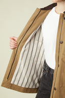 Barn Jacket pattern – open view, striped inner lining, camel jacket, hand holding the lapel – Atelier Brunette