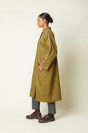 Trench Coat pattern – left profile view, trench khaki long, raglan sleeves, grey jeans, derby shoes burgundy – Atelier Brunette
